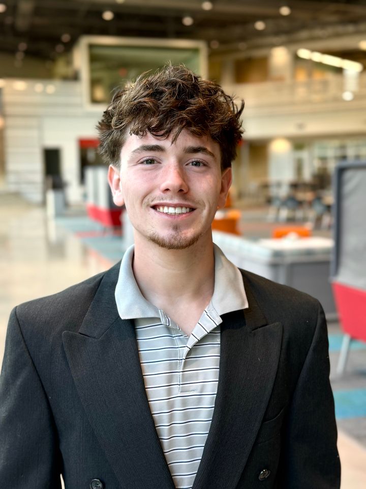 Owen Olsen, founder of Olsen Ledger, smiling in a dark blazer